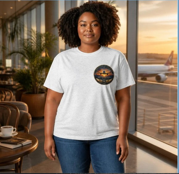 Opensky Goods tri-blend t-shirt with Emotional Escape aviation graphic, worn by a woman in an airport lounge.