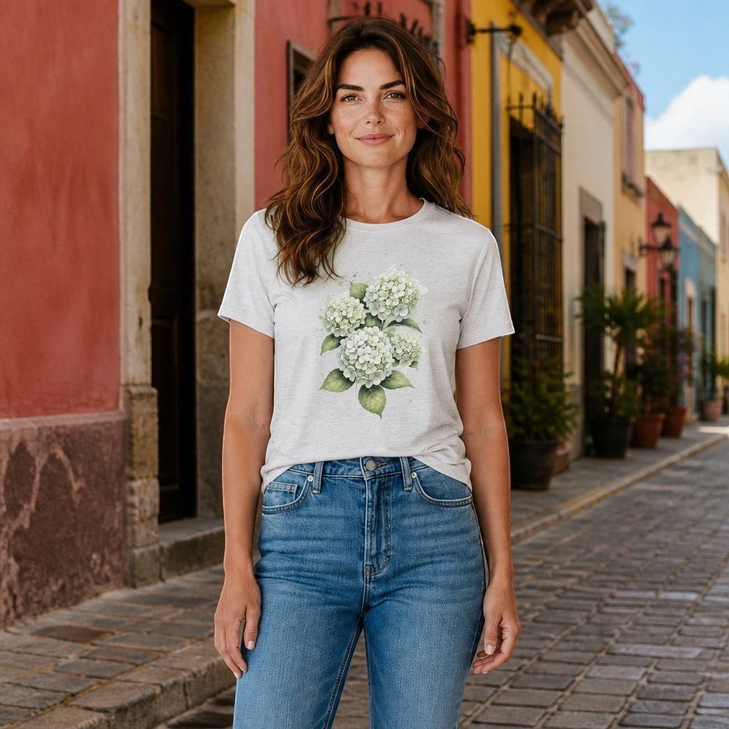 Woman wearing an Opensky Goods white tri-blend t-shirt with a watercolor hydrangea floral print on a city street.